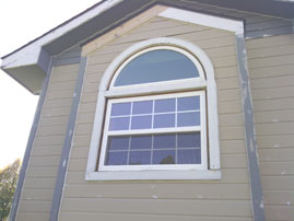 Coronet Window Company UNO single hung with colonial grids topped by a half round purchased from Home Depot.